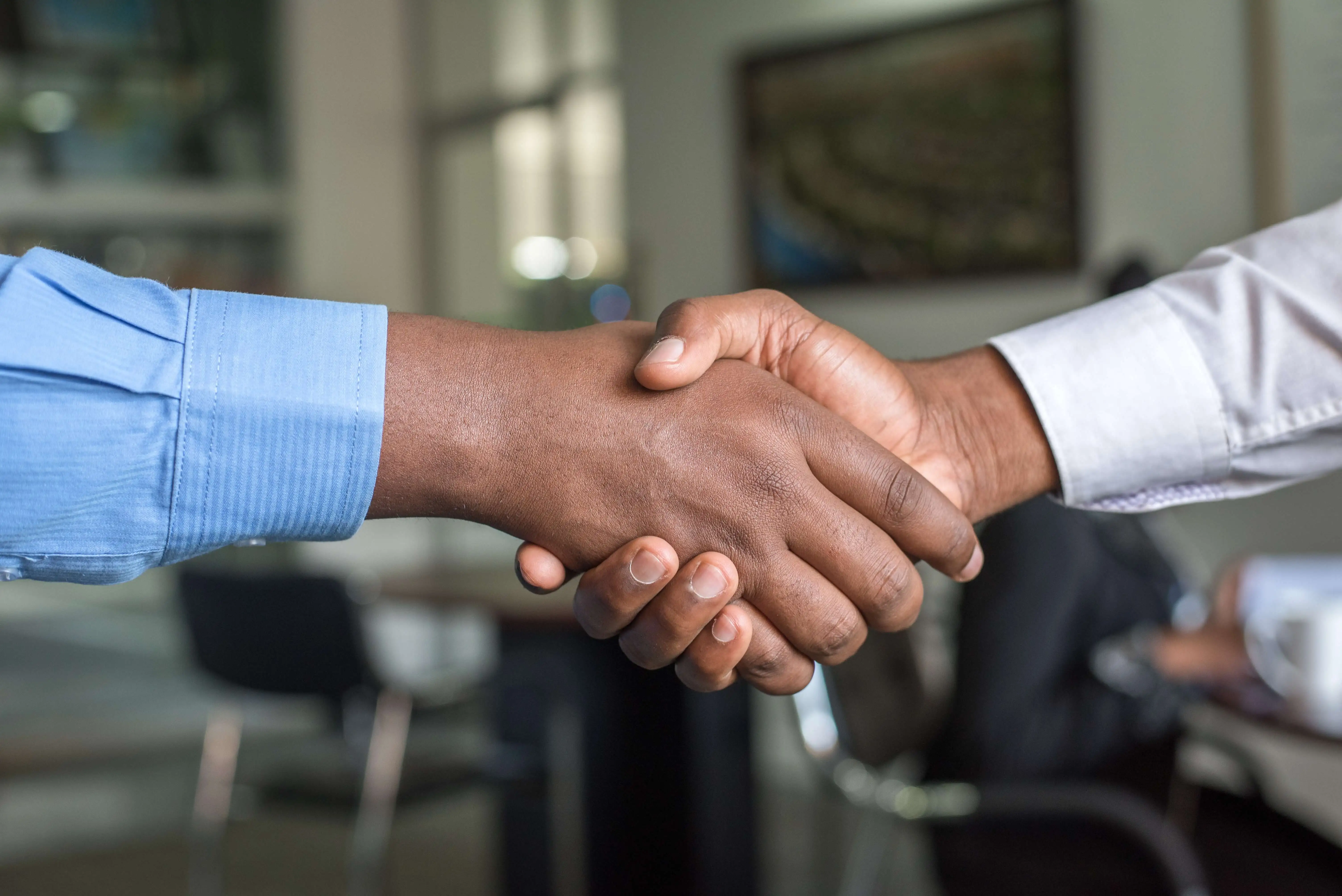 two people shaking hands in agreement of putting customer first
